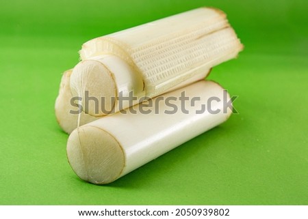 Edible Banana stem pile in studio on green Background. Ayurveda medicine food use for lose weight or get relieved from kidney stones. full of potassium and vitamin B6. Royalty-Free Stock Photo #2050939802