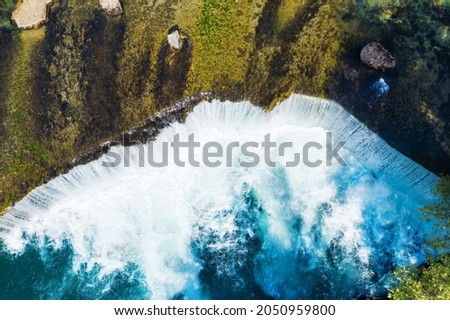 Manavgat. Waterfall on the Manavgat River in Antalya province. It is located near the ancient city of Side. Manavgat. Turkey. Alania. A wide stream of water falls from a low height. Drone shooting