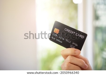 Close up of woman's hand holding a credit card.
