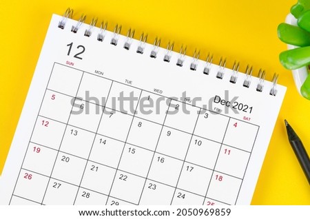 Close up December 2021 desk calendar on yellow background. Royalty-Free Stock Photo #2050969859