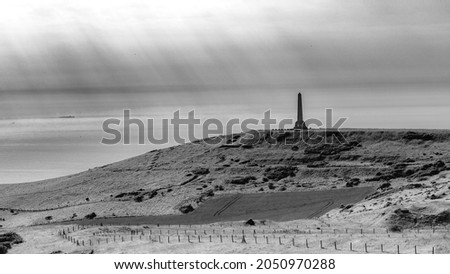 Black and white landscape photography of the cap blanc nez under a sun piercing through the clouds (Opal Coast, France)