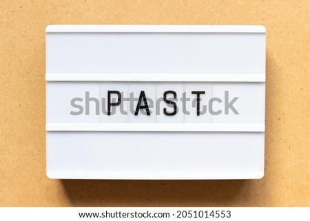 Lightbox with word past on wood background