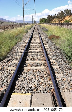 A picture of a railway line and overhead power lines. The viewpoint is along the length of the line.