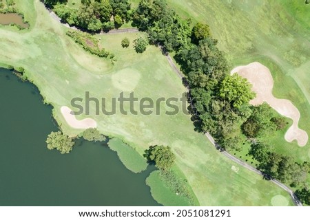 Aerial view drone shot of beautiful green golf field fairway and putting green Top down image for sport background and travel nature background Amazing view at Phuket Thailand.