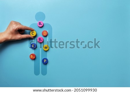 A silhouette of a man with an image of vitamins on it. A symbol of the need for vitamins for the body Royalty-Free Stock Photo #2051099930