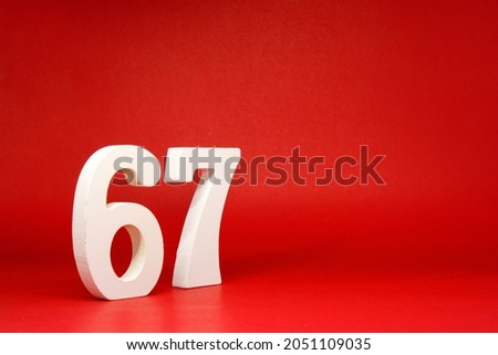 Sixty Seven ( 67 ) white number wooden Isolated Red Background with Copy Space - New promotion 67% Percentage   Business finance or birthday Concept - advertise banner picture online with copy space