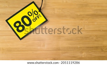 Yellow sale label on wooden background. Black friday sale.