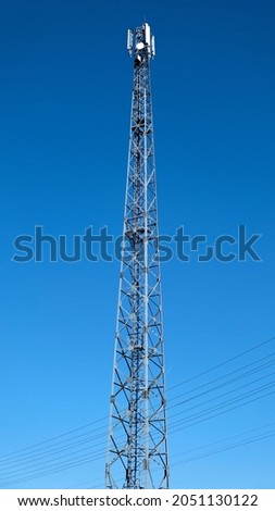Telecommunication tower of 4G and 5G cellular. Base station or base transceiver station. Wireless communication antenna transmitter. Telecommunication tower with antennas against blue sky.