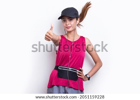 Young beautiful asian sporty woman showing a thumbs up ok gesture on white background

