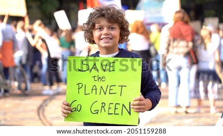 Italia, Milano , Activist boy Child 7 years old with sign Save the Planet , go green - Friday for Future Youth 4 Climate - student demonstration against climate change and global warming