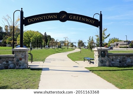 The Petoskey Greenway, connecting to downtown businesses, the Greenway Corridor  includes a 10' wide concrete path, trail head parking, and benches.