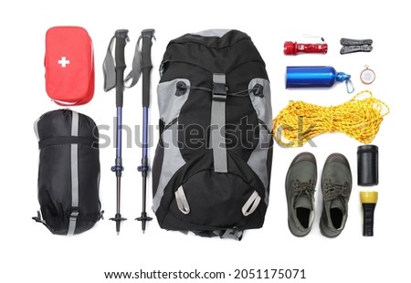 Pair of trekking poles and camping equipment for tourism on white background, top view Royalty-Free Stock Photo #2051175071