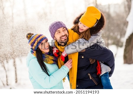 Photo of attractive family mom dad daughter piggyback happy positive smile snowy winter day walk park