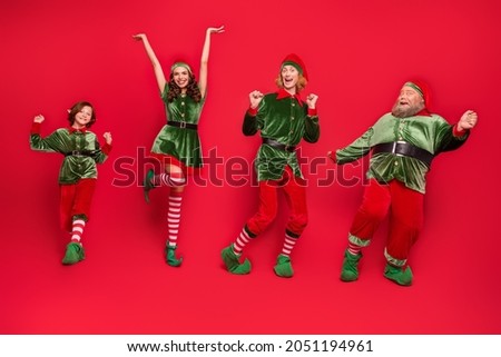 Full size photo of positive cheerful santa helper elf dance xmas holiday spirit miracle isolated on red color background