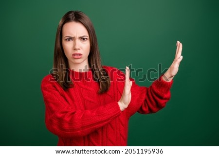 Photo portrait girl wearing knitted pullover showing stop sign rejecting isolated green color background