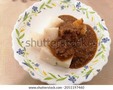 Picture of "kuah kacang" or peanut sauce with "nasi impit" or pressed rice. Traditional Malay Nusantara food usually serve during Eid or snack.