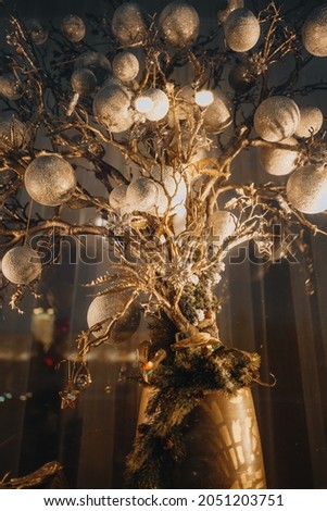Golden festive Christmas decorations. Winter holliday mood. Beautiful bokeh in the background. Happy New Year 2022