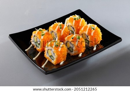 California maki sushi or California rolls or Masago maki sushi roll  in black plate isolated on white background.