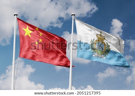 Republic of China and San Marino two flags on flagpoles and blue cloudy sky background