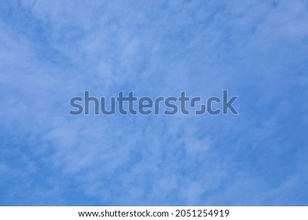 background of blue autumn sky with small white clouds