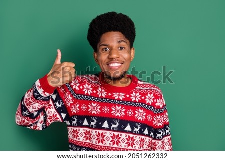 Photo of positive cheerful reliable promoter guy raise thumb up wear print sweater isolated green color background