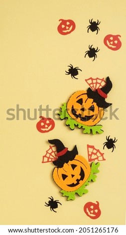 Abstract Halloween composition, background for halloween card, vertical banner. silhouettes of pumpkin and spiders. 