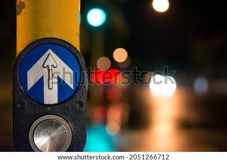 A closeup shot of a button on a traffic light