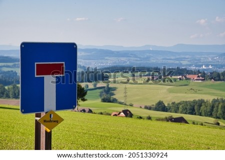 A shot of a dead end no through way sign on a country road with Ruswiler Berg in the background