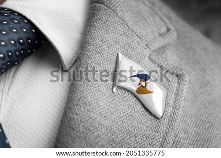 Metal badge with the flag of Eurasian Economic Union on a suit lapel Royalty-Free Stock Photo #2051335775