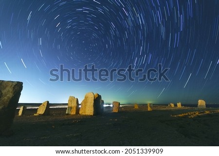 View of rocks and star trails in the Negev Desert, Southern Israel Royalty-Free Stock Photo #2051339909