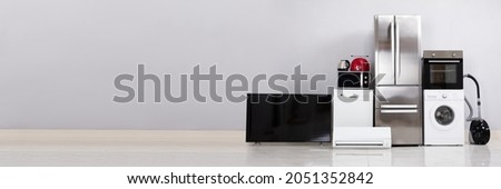 Electronic Household Appliance. Electric Kitchen Fridge And Television Royalty-Free Stock Photo #2051352842