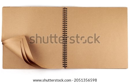 Opened album with sepia flipped pages and metal binding isolated on white background. Royalty-Free Stock Photo #2051356598