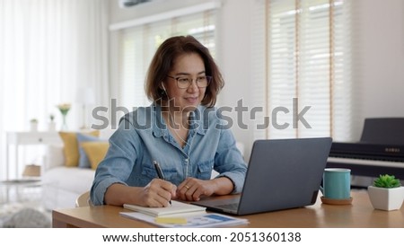 Asia adult happy people or sme owner latin lady sit consult talk in online seminar reskill upskill job discuss class for worker on desk table work at home in remote teach advice by digital training. Royalty-Free Stock Photo #2051360138