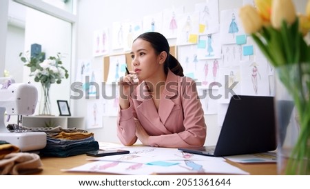 Woman seller SME retail store owner work hard worry stress in bad news on laptop at home office desk. Asian people crisis tailor job issue feel tired tough and upset in cash money loss or loan debt. Royalty-Free Stock Photo #2051361644