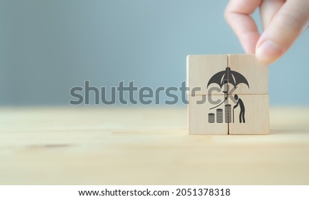Pension insurance, senior business, life insurance and support seniors concepts for aging society. Wooden cubes with retirement assurance symbol standing on table with grey background. Used for banner Royalty-Free Stock Photo #2051378318