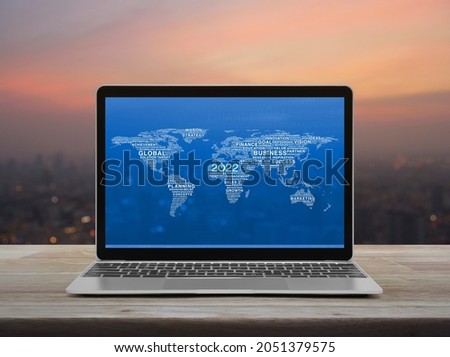 Start up 2022 business icon with words map with laptop computer on table over blur of cityscape on warm light sundown, Happy new year 2022 global business, Elements of this image furnished by NASA