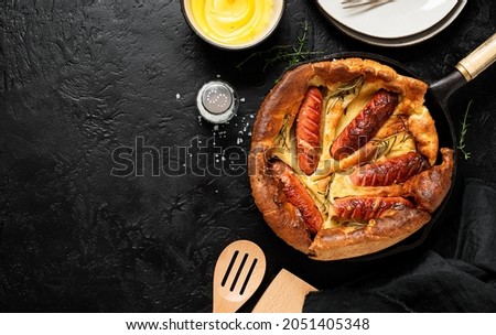 Toad in the hole, Sausage Toad, traditional English dish of sausages in Yorkshire pudding batter. top view	