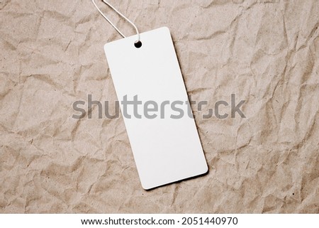 white tags, sale tag on vintage craft paper background. Mockup, copy space for text, top view