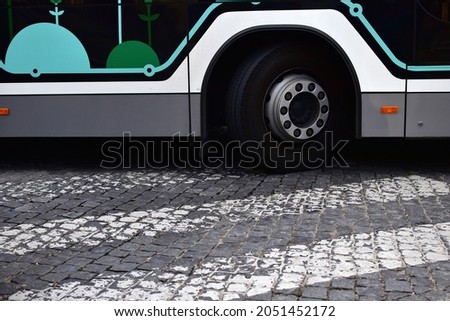 Front wheel of a city bus at pedestrian crossing