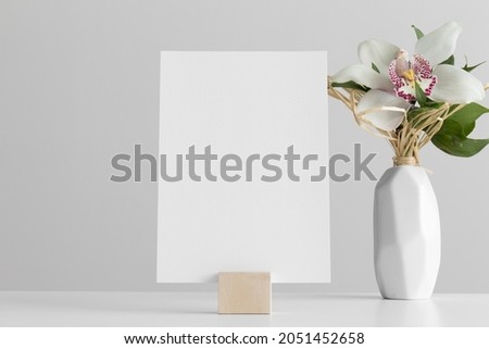 Wedding table number card mockup with a floral arrangement. Royalty-Free Stock Photo #2051452658
