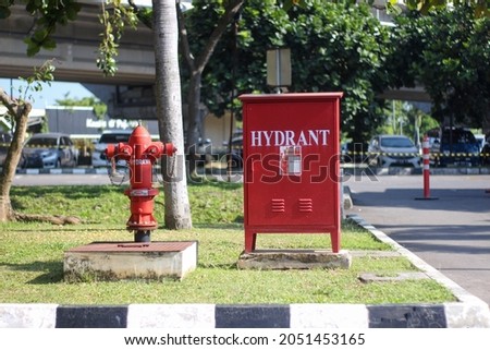 picture of red hydrant in parking area