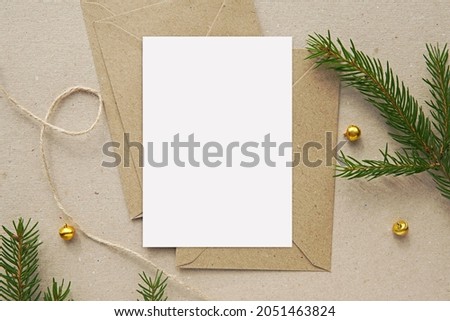 Christmas greeting card mockup, blank vertical notecard, postcard, craft paper envelopes, fir tree branches.
