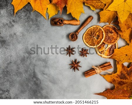 Autumn yellow leaves, cinnamon,  oranges and star anise. Background picture. Autumn background.