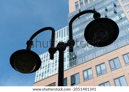 Close up photo of a street lamp with the modern office high rise building in Frankfurt downtown