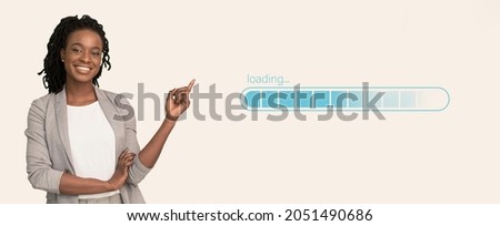 Happy black business lady pointing at loading progress bar on light studio background, collage. Banner design. Uploading process indicator, data transfer interface concept Royalty-Free Stock Photo #2051490686