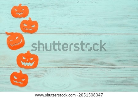 hinoween, paper orange pumpkins lie in a row on a light wooden background. High quality photo.space for text 