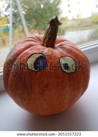 Orange pumpkin with drawn eyes