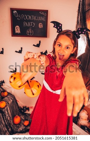Happy Halloween! Child in carnival costumes enjoying party.
