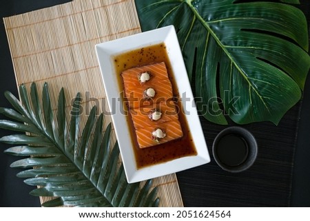 Salmon sashimi with sauce on white plate. Salmon sushi served restaurant. Japanese restaurant. Japanese traditional food. Healthy food concept. Menu