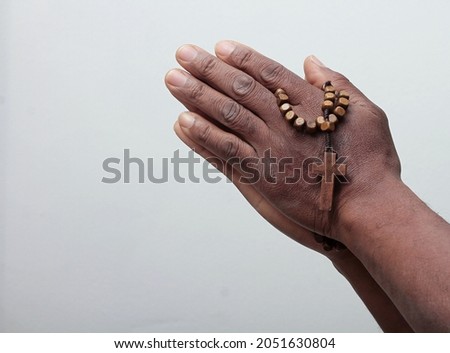 hand with cross praying to God on grey background with people stock image stock photo Royalty-Free Stock Photo #2051630804